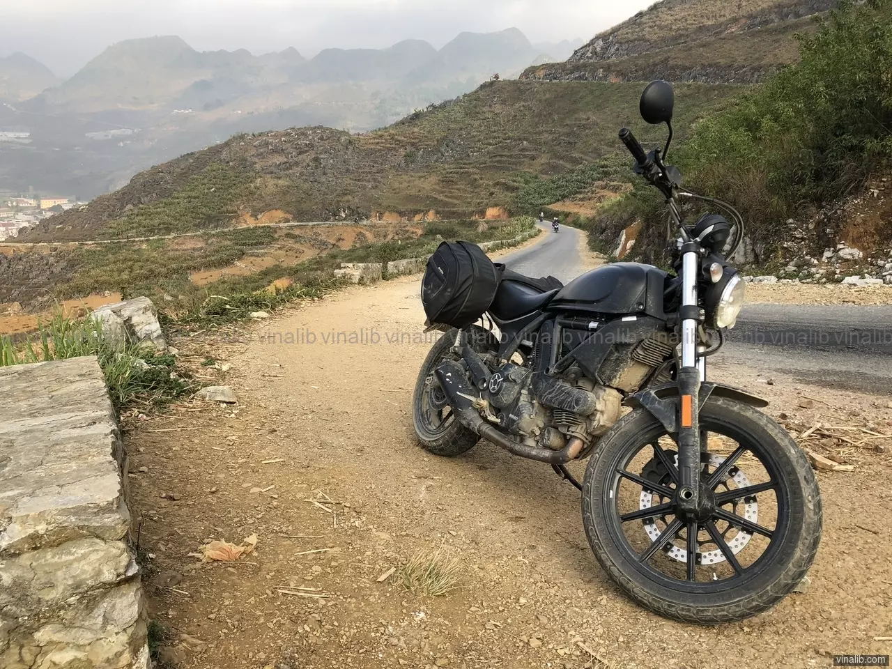 A Ducati Scrambler on a curvy road in Meo Vac district, Ha Giang province - Vinalib Stock Pictures