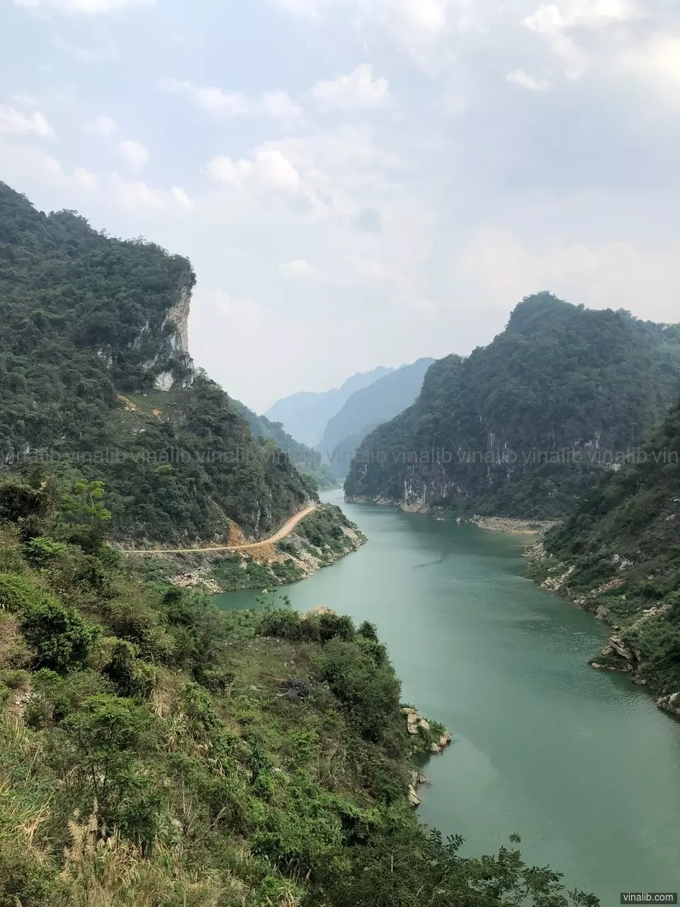 A road, along the river, in a valley of Hoa Binh province - Vinalib Stock Pictures
