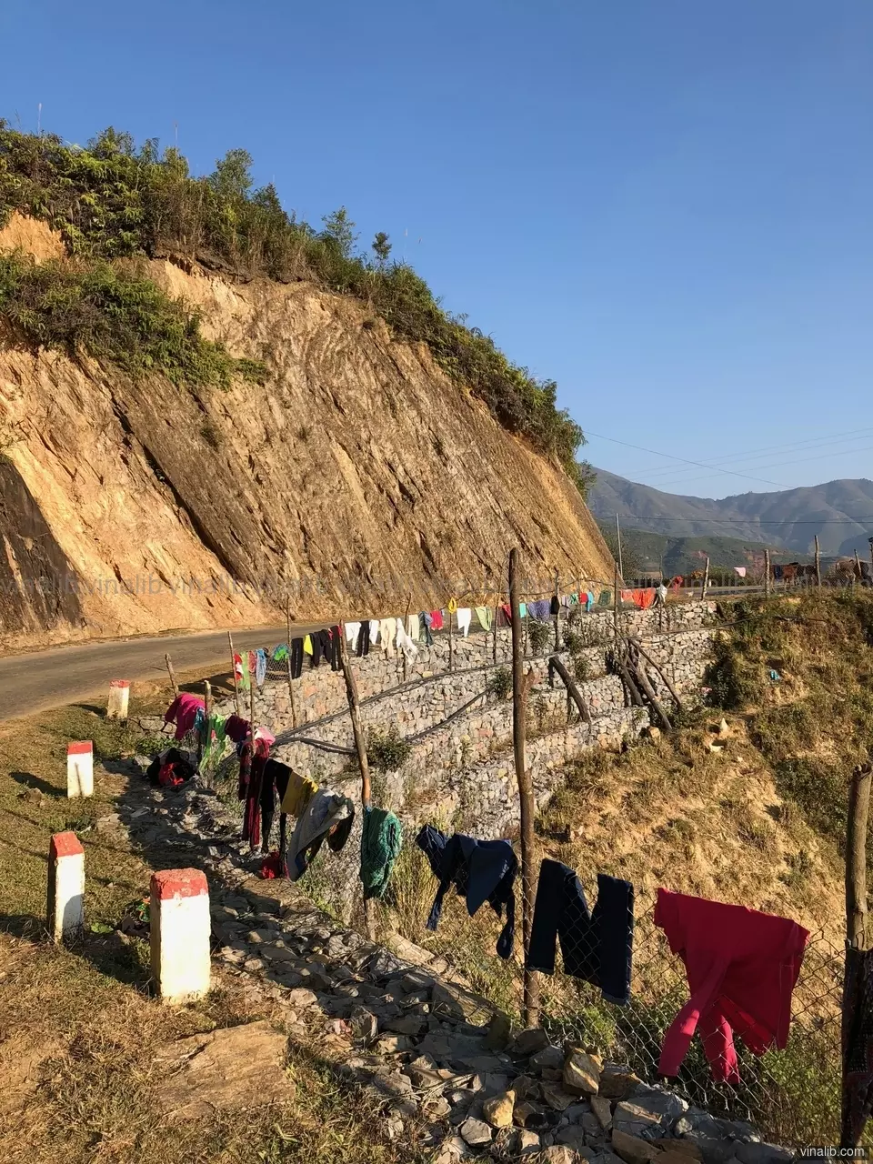 Colorful clothes drying on the side of the road - Vinalib Stock Pictures